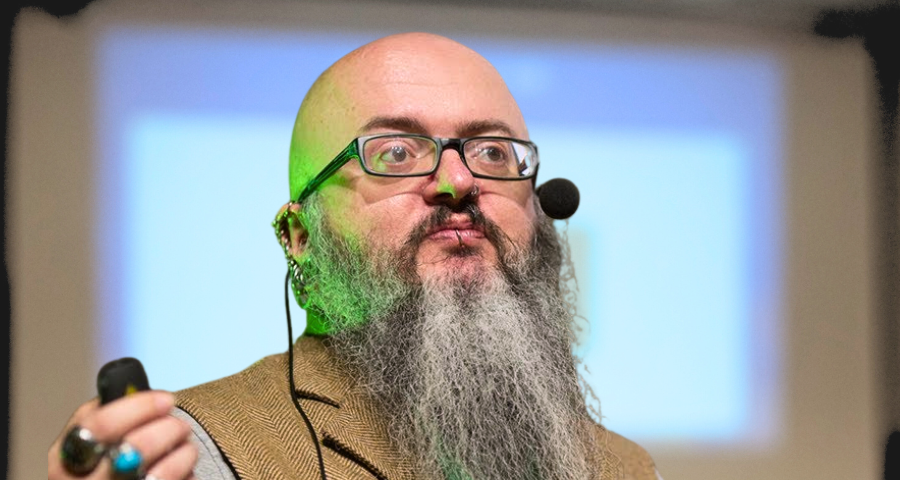 Ian Cooper, bear man talking with microphone