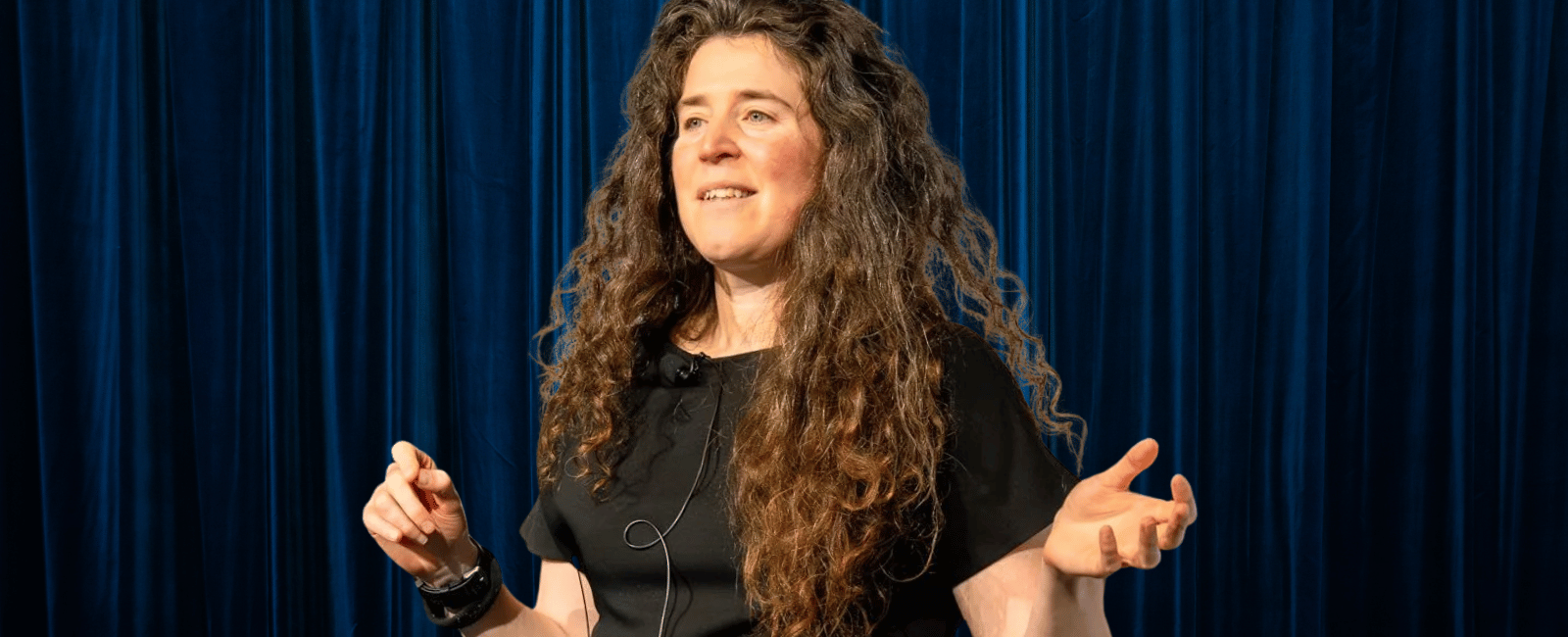 Andrea Magnorsky on a stage while giving a talk